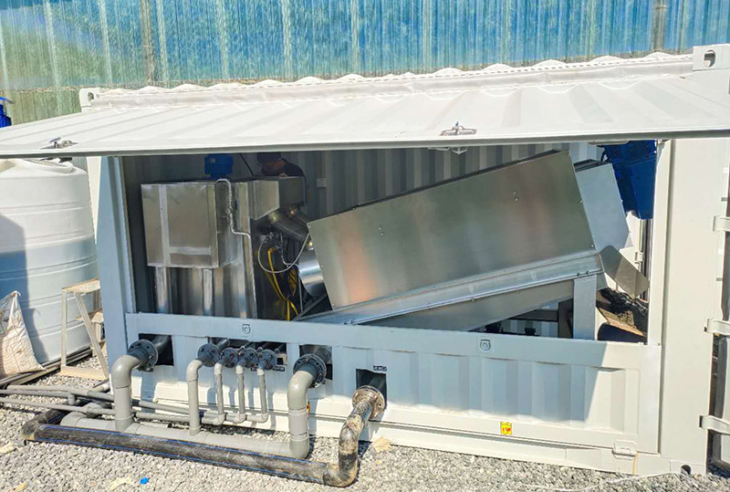 Skid-mounted sludge dewatering container